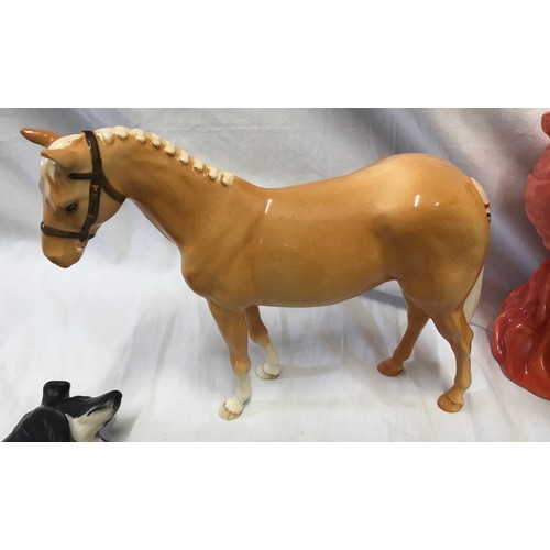 114 - A pottery selection to include a Beswick light brown horse 16.5cms , a Beswick black and white Colli... 