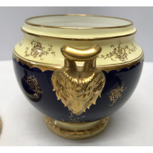 119 - A Coalport signed blue ground and gilt lidded vase with a painted panel of a country scene near Dove... 