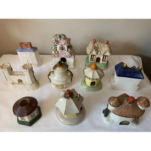 121 - Ten Staffordshire cottages to include money boxes and pastille burners, some 19thC.