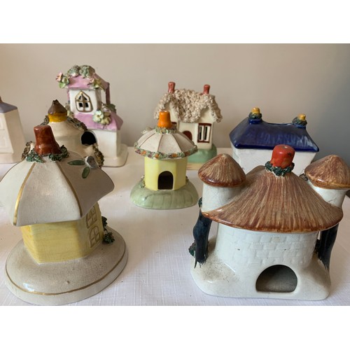 121 - Ten Staffordshire cottages to include money boxes and pastille burners, some 19thC.