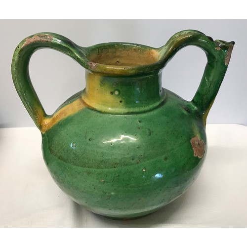 127 - A green glazed pottery two handled jug from Provence circa 1850 approx. 21cms h x 24cms w.