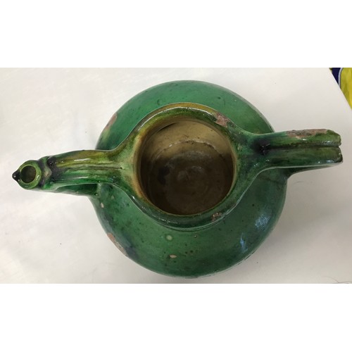 127 - A green glazed pottery two handled jug from Provence circa 1850 approx. 21cms h x 24cms w.