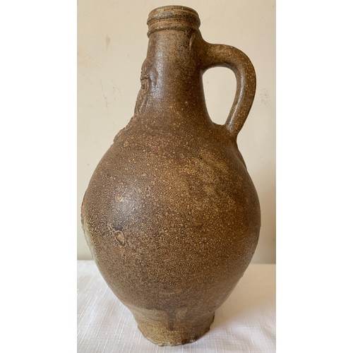 129 - A late 17thC salt glazed stoneware Bellarmine jug 26cms h, unearthed by a farmers plough in Holderne... 