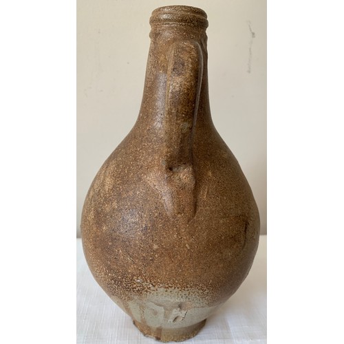 129 - A late 17thC salt glazed stoneware Bellarmine jug 26cms h, unearthed by a farmers plough in Holderne... 