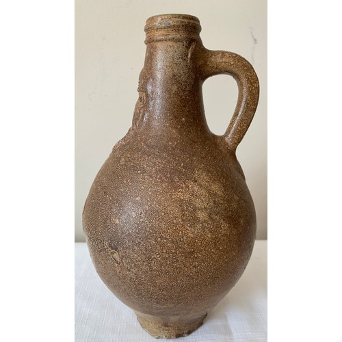 129 - A late 17thC salt glazed stoneware Bellarmine jug 26cms h, unearthed by a farmers plough in Holderne... 