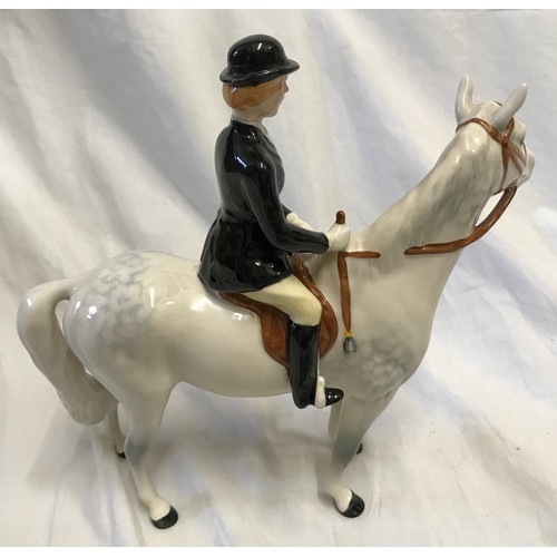 146 - A Beswick Huntswoman on white/grey dappled horse. Approx. 21.5cms h x 21cms l.