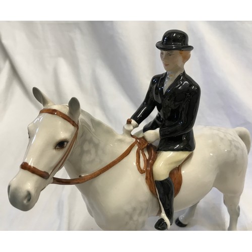 146 - A Beswick Huntswoman on white/grey dappled horse. Approx. 21.5cms h x 21cms l.