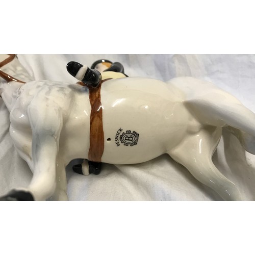 146 - A Beswick Huntswoman on white/grey dappled horse. Approx. 21.5cms h x 21cms l.