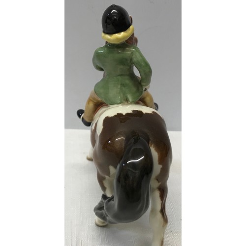 148 - A Beswick Huntsgirl on a skewbald pony. Approx. 14cms h x 15cms l.