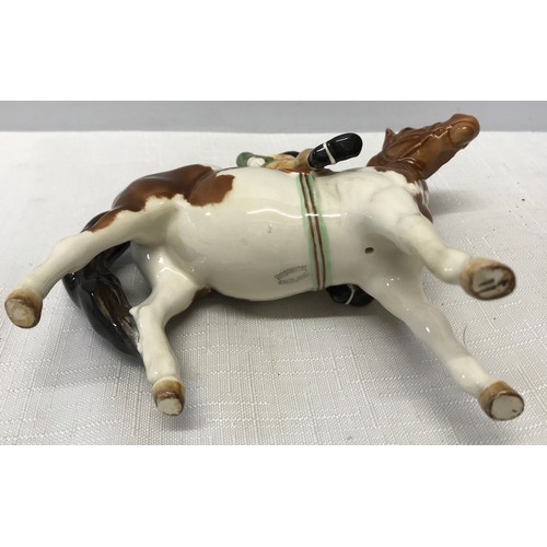 148 - A Beswick Huntsgirl on a skewbald pony. Approx. 14cms h x 15cms l.