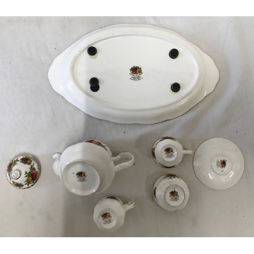 176 - A Royal Albert Old Country Roses miniature Tea Service set to include a teapot 9.5cms h, tea cup and... 