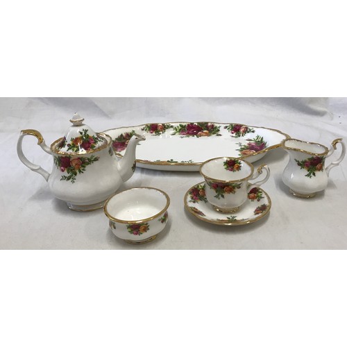 176 - A Royal Albert Old Country Roses miniature Tea Service set to include a teapot 9.5cms h, tea cup and... 