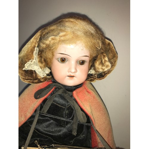 208 - A good example of a Victorian pedlar doll on a circular ebonised base under a glass dome. Doll with ... 