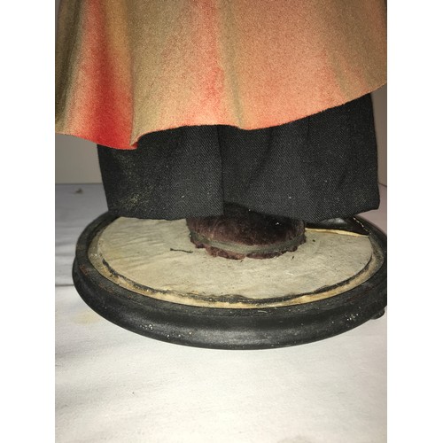 208 - A good example of a Victorian pedlar doll on a circular ebonised base under a glass dome. Doll with ... 