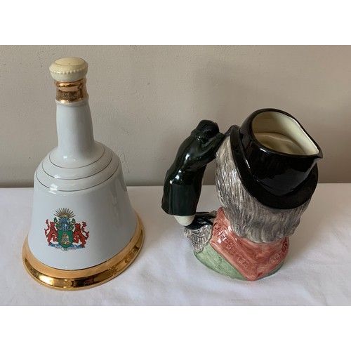 231 - A Doulton Toby jug “The Walrus and Carpenter” together with a Wade Bells Whisky commemorative decant... 