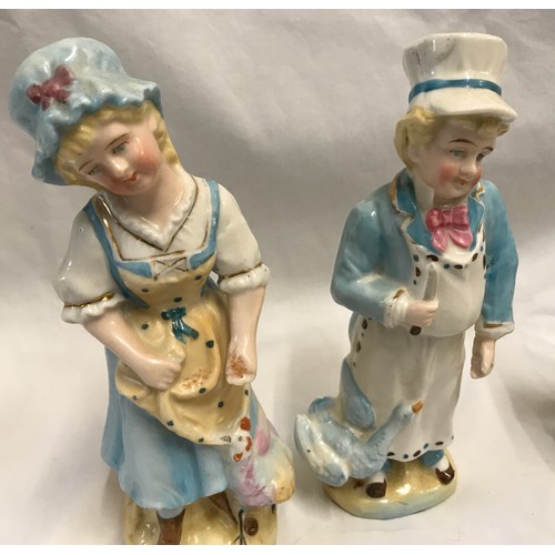 236 - Two pairs of continental pottery figurines. Boy and Girl with brollies 18cms h and maid and cook 18c... 