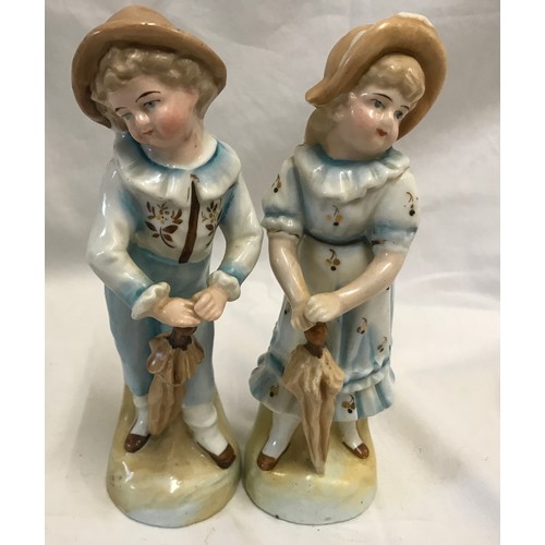 236 - Two pairs of continental pottery figurines. Boy and Girl with brollies 18cms h and maid and cook 18c... 