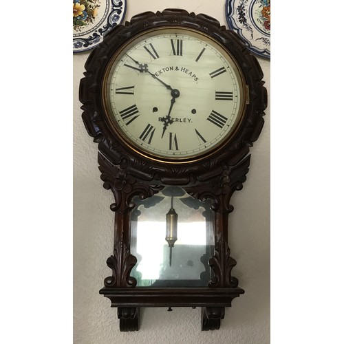 240 - A 19thC carved mahogany wall clock with visible pendulum. Rexton & Heap Beverley. 73 h x 42 w.