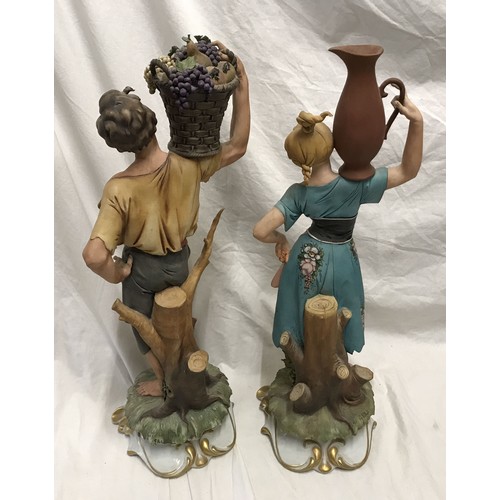 244 - Pair of Capodimonte tall figurines signed G Pellati, lady with water jug and man with basket of frui... 