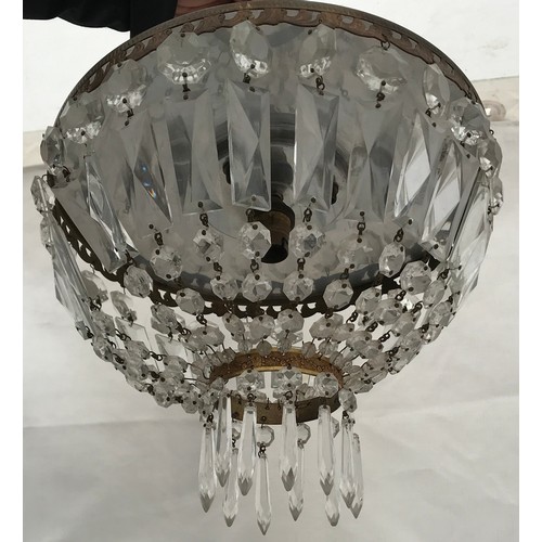 253 - A small two tiered chandelier with symmetrical cut glass pendants. To take a single bulb. 30cm w x 2... 