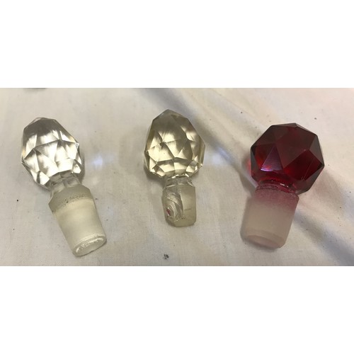 266 - Three glass scent bottles to include one cranberry coloured 12cm h with sterling silver rim, one cle... 