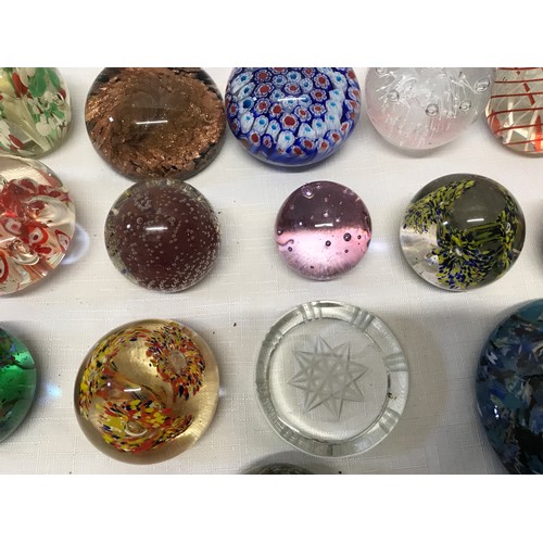 283 - A collection of 22 unmarked glass paperweight, floral, bubble, multicoloured etc.