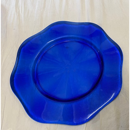 286 - A set of eight good quality heavy cobalt blue glass charger plates, with a scalloped edge and a text... 