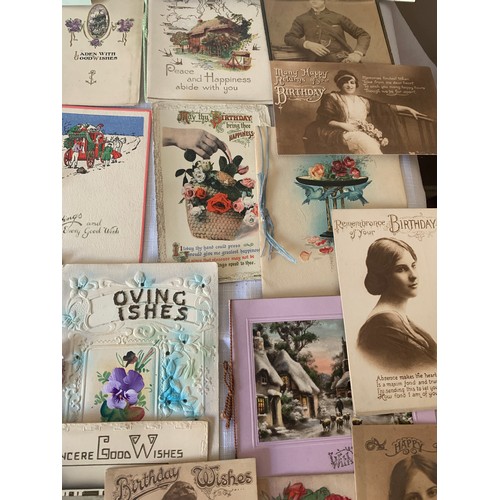 907 - A collection of early 20thC greetings cards and photographs.