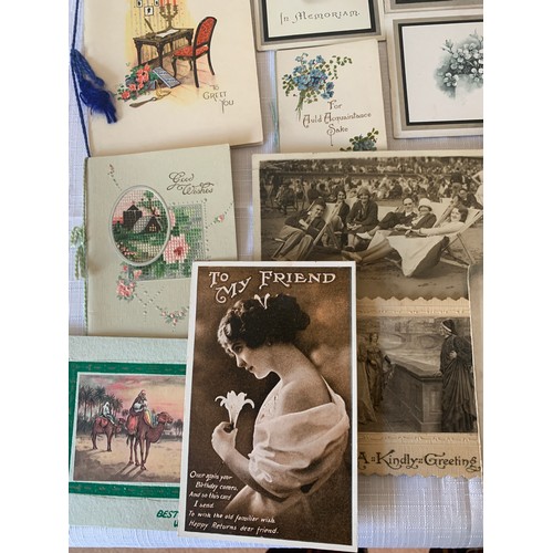 907 - A collection of early 20thC greetings cards and photographs.