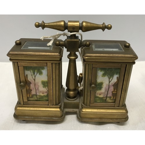 922 - A small brass carriage clock and barometer with carry handle and double key and painted pottery pane... 