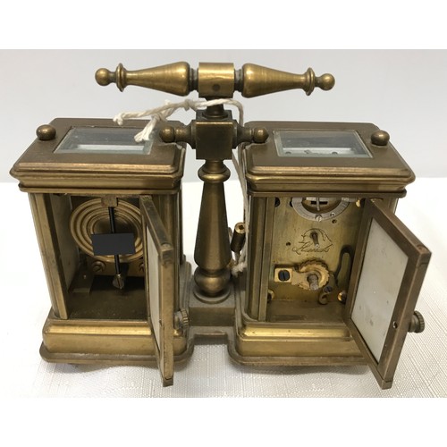 922 - A small brass carriage clock and barometer with carry handle and double key and painted pottery pane... 