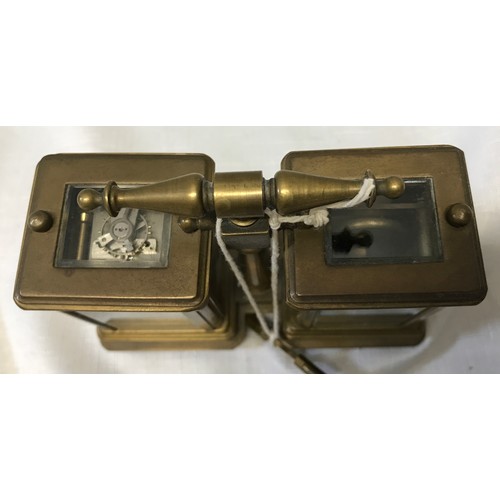 922 - A small brass carriage clock and barometer with carry handle and double key and painted pottery pane... 