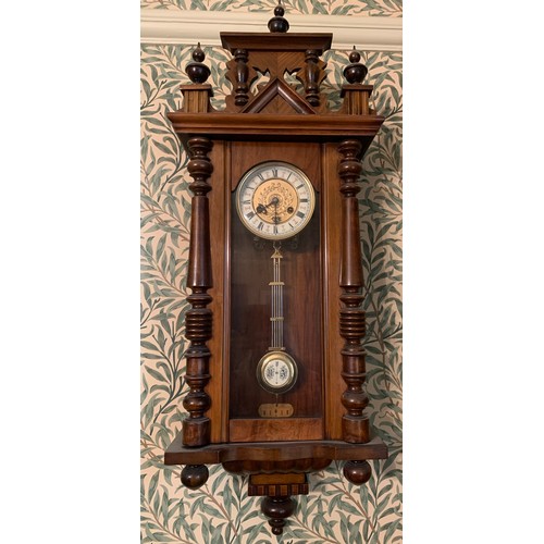 923 - A 19thC mahogany Vienna wall clock with brass and enamel dial and pendulum. 99cms h x 35cms w.