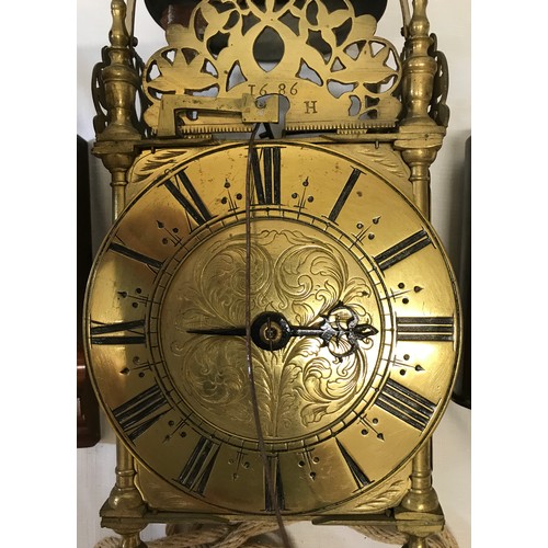 924 - An old reproduction lantern clock with pulley, weight and wooden corner mounted shelf. A single poin... 