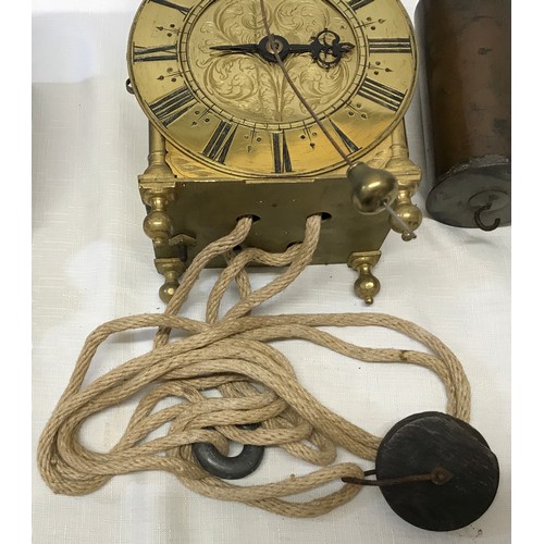 924 - An old reproduction lantern clock with pulley, weight and wooden corner mounted shelf. A single poin... 