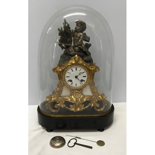 926 - A glass domed decorative mantle clock with cherub mount and enamel face. Clock approx. 33cm h, with ... 