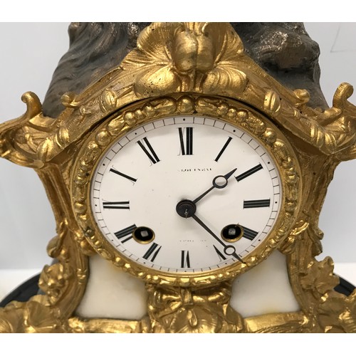 926 - A glass domed decorative mantle clock with cherub mount and enamel face. Clock approx. 33cm h, with ... 