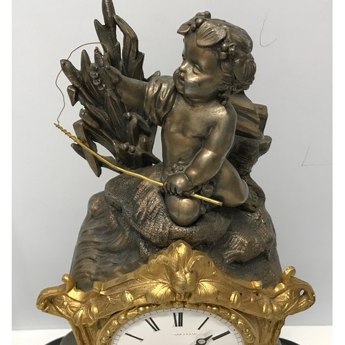 926 - A glass domed decorative mantle clock with cherub mount and enamel face. Clock approx. 33cm h, with ... 