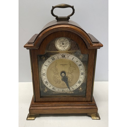 929 - A mahogany cased Elliot mantle clock with a cherub decorated brass face. Retailed by Carmichaels of ... 