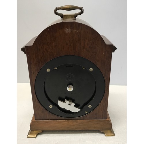 929 - A mahogany cased Elliot mantle clock with a cherub decorated brass face. Retailed by Carmichaels of ... 