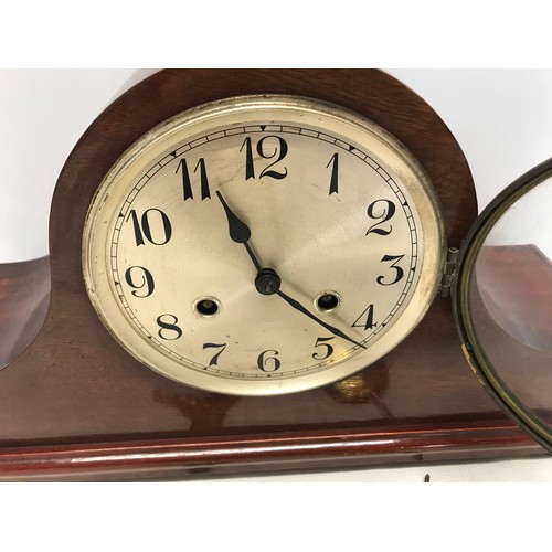 931 - A mahogany cased mantle clock  with DRM brass movement 25cms h  x 14cms d x 42cms w.  with a steel f... 