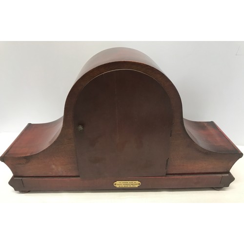 931 - A mahogany cased mantle clock  with DRM brass movement 25cms h  x 14cms d x 42cms w.  with a steel f... 