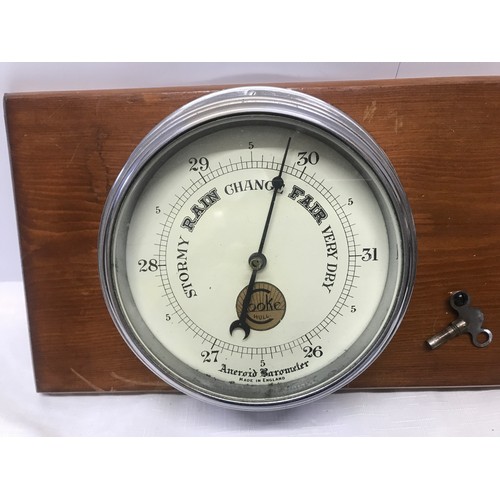 932 - A chrome cased ships clock and aneroid barometer mounted on pine by Cooke of Hull. Back plate width ... 