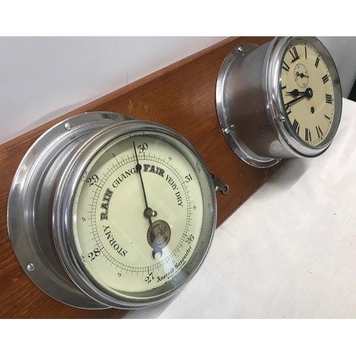 932 - A chrome cased ships clock and aneroid barometer mounted on pine by Cooke of Hull. Back plate width ... 