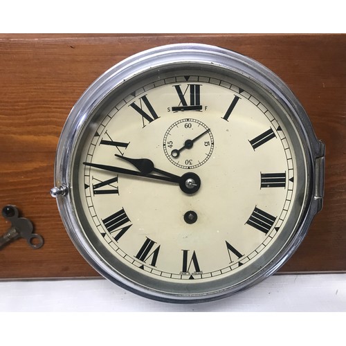 932 - A chrome cased ships clock and aneroid barometer mounted on pine by Cooke of Hull. Back plate width ... 