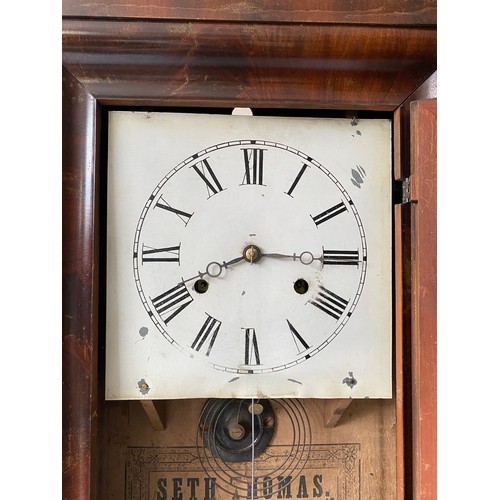 934 - An American Seth Thomas wall mounted cased clock with walnut veneer and Victorian print to door pane... 