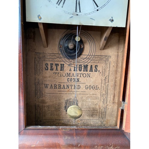 934 - An American Seth Thomas wall mounted cased clock with walnut veneer and Victorian print to door pane... 