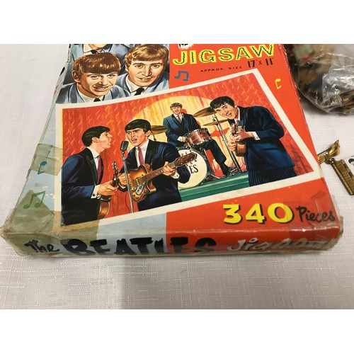 948 - The Beatles, 340 piece jigsaw puzzle and a novelty brooch of book form with pull out portfolio photo... 