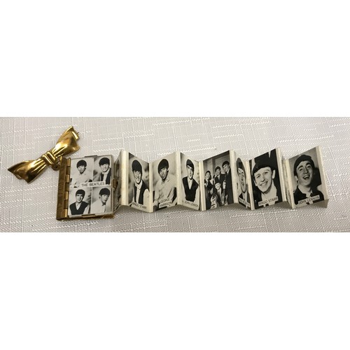 948 - The Beatles, 340 piece jigsaw puzzle and a novelty brooch of book form with pull out portfolio photo... 