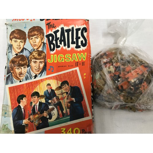 948 - The Beatles, 340 piece jigsaw puzzle and a novelty brooch of book form with pull out portfolio photo... 